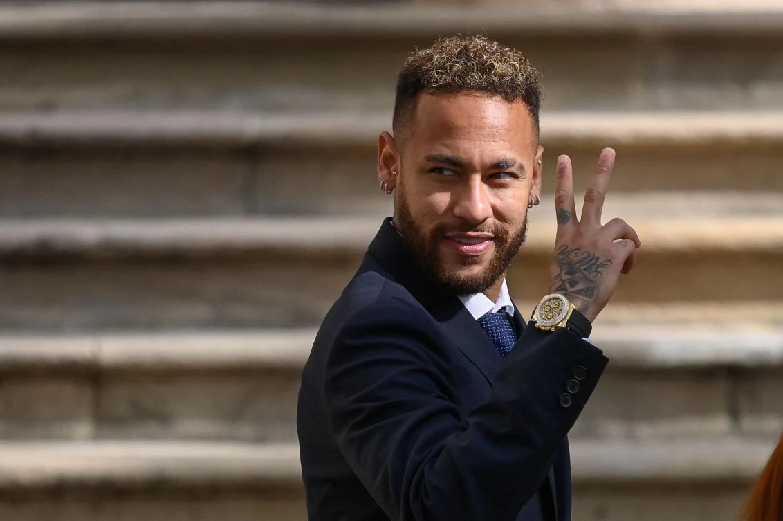 PSG’s Brazilian forward Neymar gestures as he leaves after attending a hearing at the courthouse in Barcelona on Tuesday on the second day of his trial. (AFP)