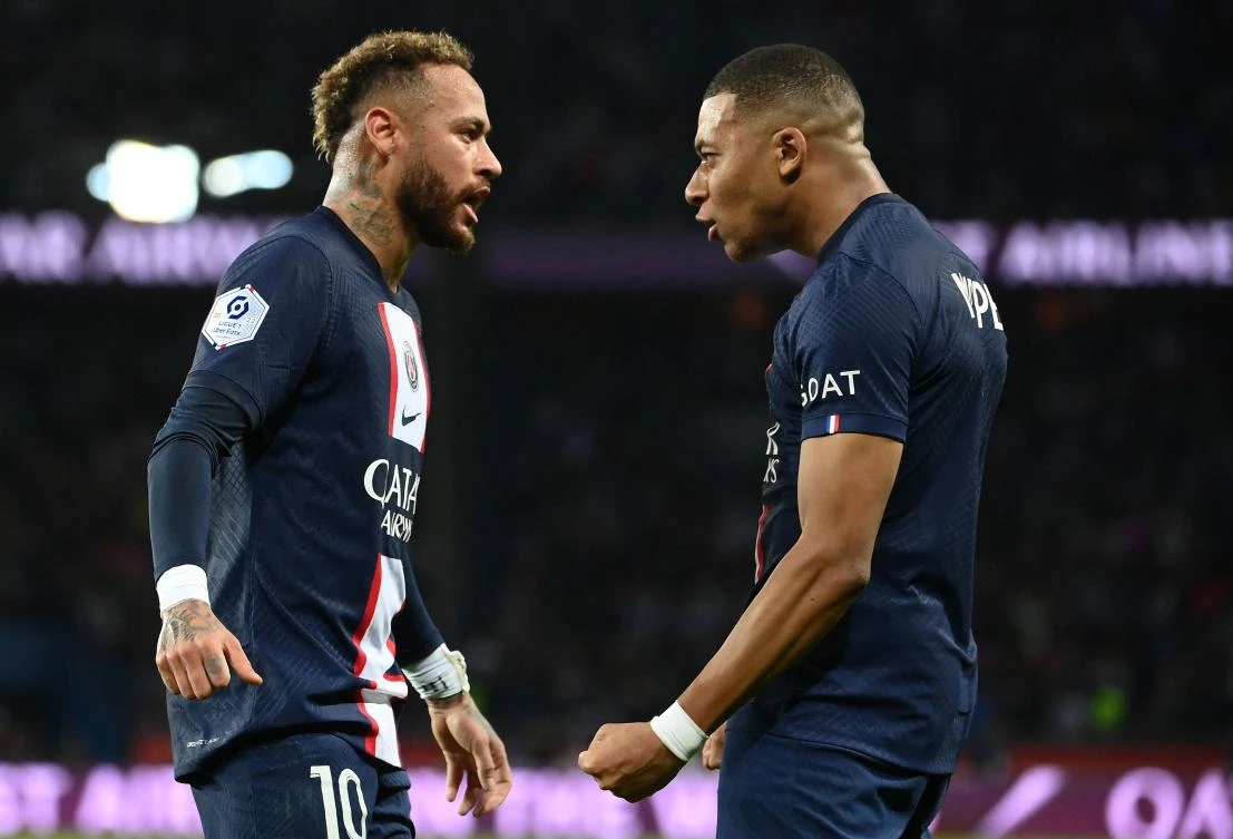 PSG’s Brazilian forward Neymar celebrates after scoring with French forward Kylian Mbappe during their French L1 match against Olympique de Marseille at the Parc des Princes Stadium in Paris, on Sunday. (AFP)