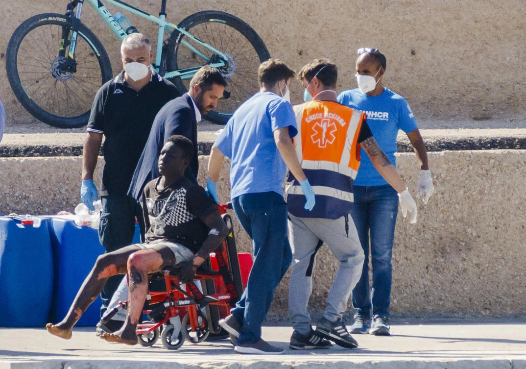 Survivors are disembarked on the tiny Sicilian Island of Lampedusa, Italy, on. (AP)