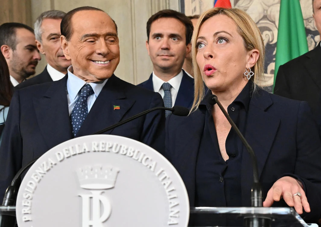 President of the Italian party Fratelli d’Italia (Brothers of Italy) Giorgia Meloni next to former Prime Minister and leader of Forza Italia party Silvio Berlusconi, addresses the media in Rome on Friday. (AFP)