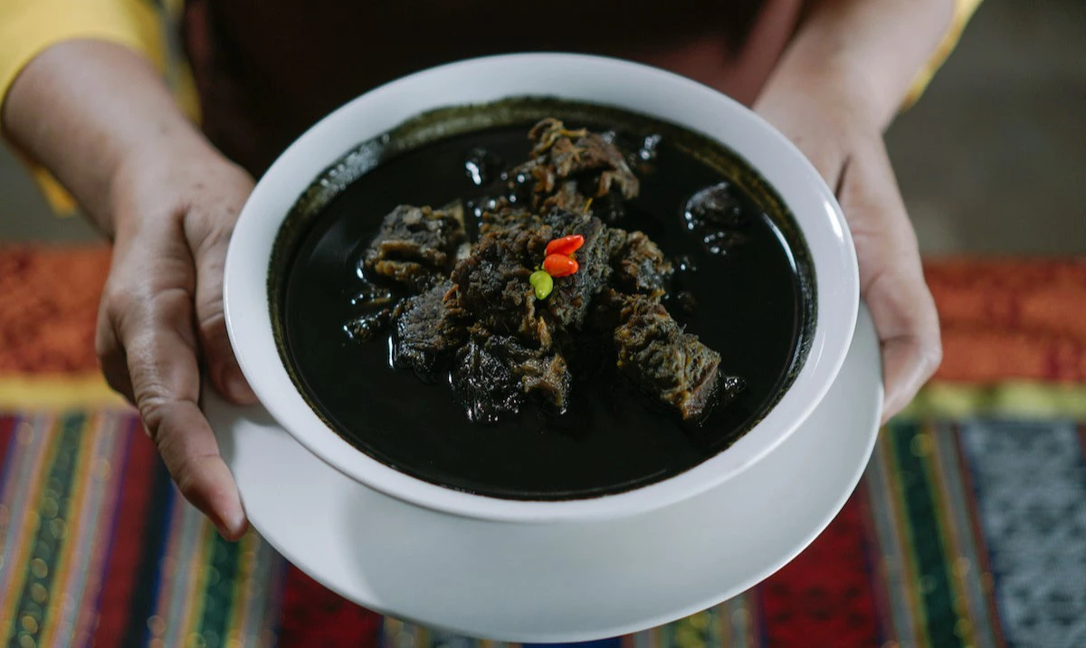This file photo shows a bowl of tiyula itum, which is sometimes known as 'royal beef stew,' historically linked to the dining rooms of the Sultanate of Sulu and nowadays served on special occasions. (Photo courtesy: Philippine Department of Tourism)
