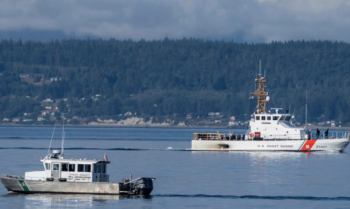 A US Coast Guard boat, County Sheriff boat search the area, on Sept. 5, 2022, near Freeland, Washington on Whidbey Island north of Seattle. (AP)