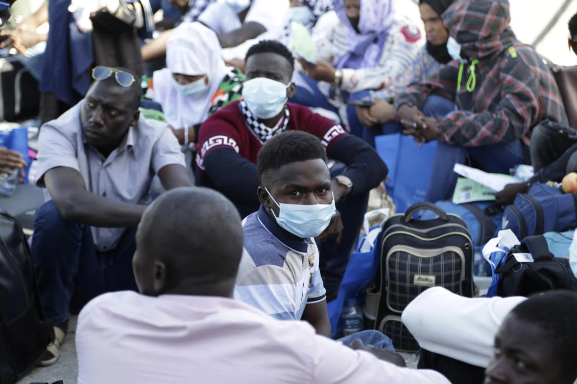 Migrants wait to board a flight in Misrata, Libya, on Monday. (AP)