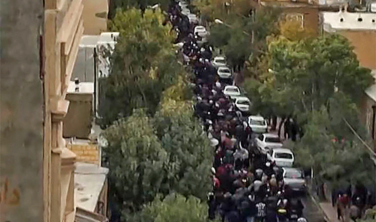 This image grab from a UGC video posted on October 27, 2022, shows protesters marching on a street in Iran's Kurdish city of Mahabad as demonstrations re-erupt a day after a protester was killed in a rally commemorating the 40th day since Mahsa Amini's death. (AFP)