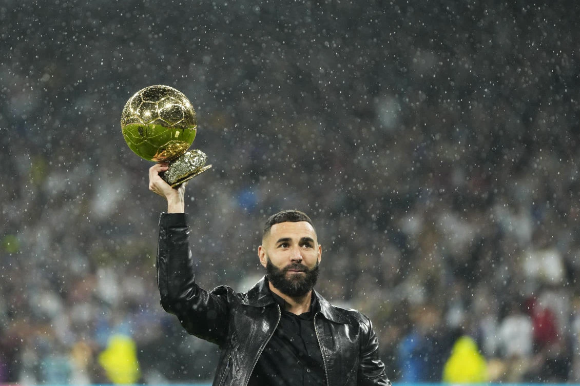 Real Madrid’s Karim Benzema holds his 2022 Ballon d’Or trophy prior to their Spanish La Liga match against Sevilla on Oct. 22, 2022. (AP)