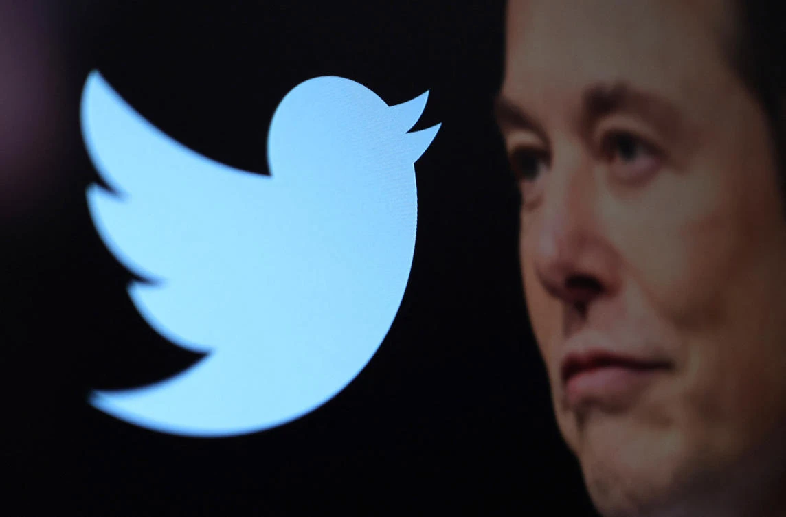 Twitter logo and a photo of Elon Musk are displayed through magnifier in this illustration taken on Thursday. (Reuters)