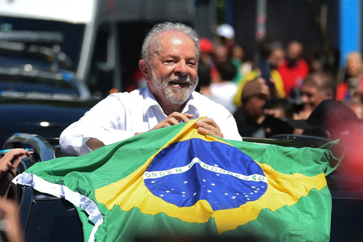 Luiz Inacio Lula da Silva holds a Brazilian flag after casting his vote at a polling station in Sao Paulo, Brazil, on Oct. 30, 2022. (AP)