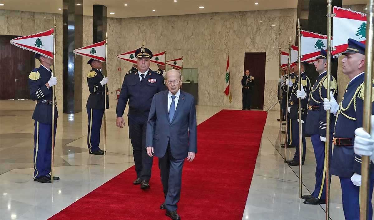 Outgoing Lebanese President Michel Aoun reviews honor guards as he leaves the presidential palace a day before his six-year term officially ends, in Baabda, Lebanon, on October 30, 2022. (REUTERS)