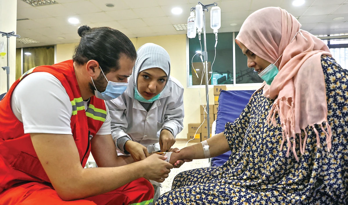 Health workers attend to a suspected cholera patient inside a field hospital in Bebnine, Akkar district, northern Lebanon. (Reuters/File)