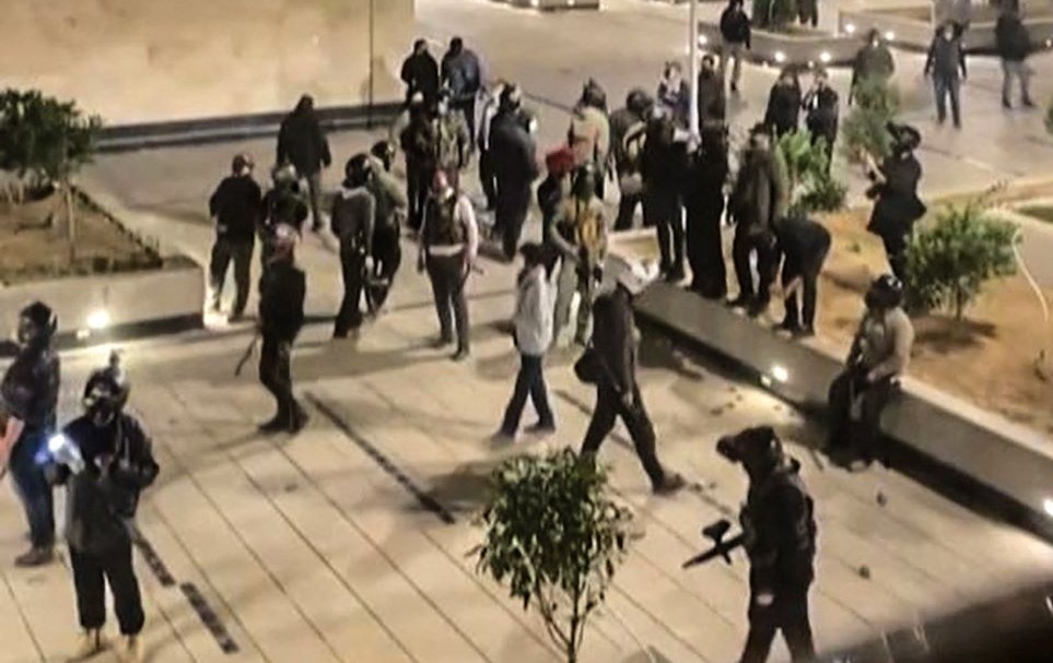 Security forces warn the residents of an apartment complex, Chitgar, Tehran, Iran, Nov. 1, 2022. (Screengrab/AFP)