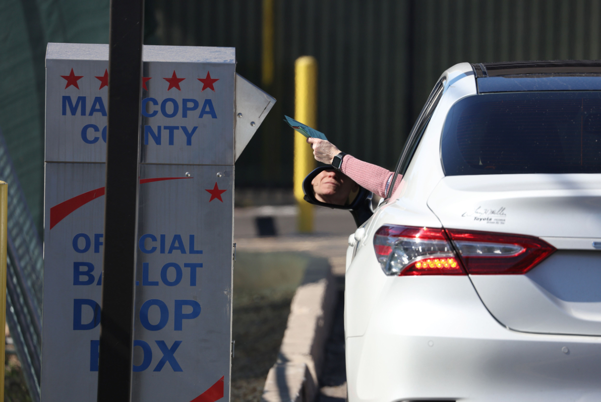 A voter drops their ballot into a drop box outside of the Maricopa County Tabulation, Election Center in Phoenix, Arizona. (AP)