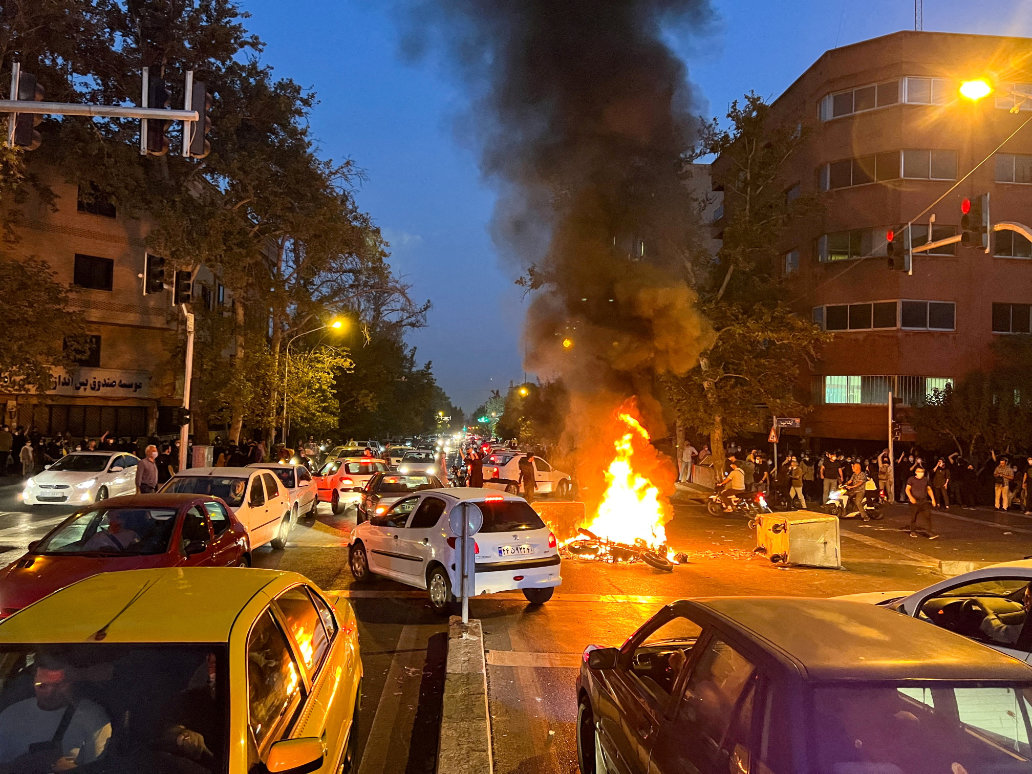 A police motorcycle burns during a protest over the death of Mahsa Amini. (Reuters)