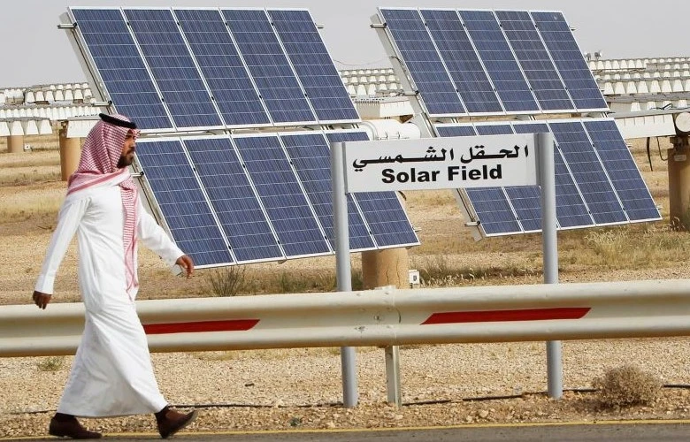 A Saudi man walks past a field of solar panels at King Abdulaziz City for Science and Technology (KACST). (Reuters)