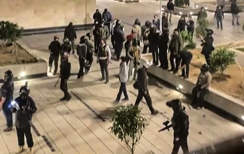 Security forces warn the residents of an apartment complex, Chitgar, Tehran, Iran, Nov. 1, 2022. (Screengrab/AFP)