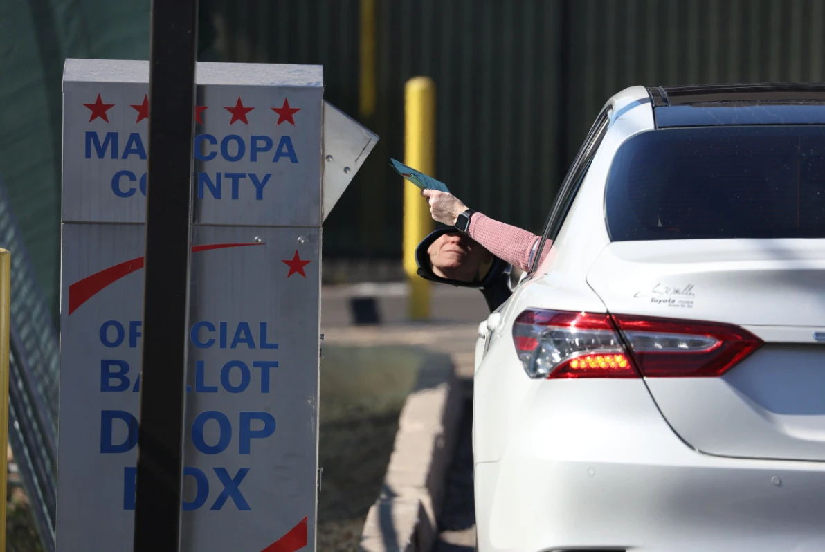 A voter drops their ballot into a drop box outside of the Maricopa County Tabulation, Election Center in Phoenix, Arizona. (AP)