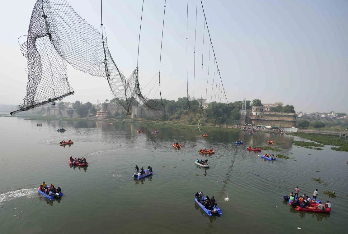 A century-old cable suspension bridge collapsed into the river Sunday evening, sending hundreds plunging in the water in one of the country's worst accidents in years. (AP)
