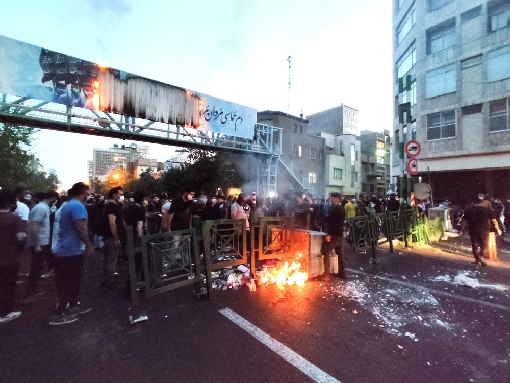 People light a fire during a protest over the death of Mahsa Amini, a woman who died after being arrested by the Islamic republic's "morality police", in Tehran on September 21, 2022. (West Asia News Agency via Reuters)