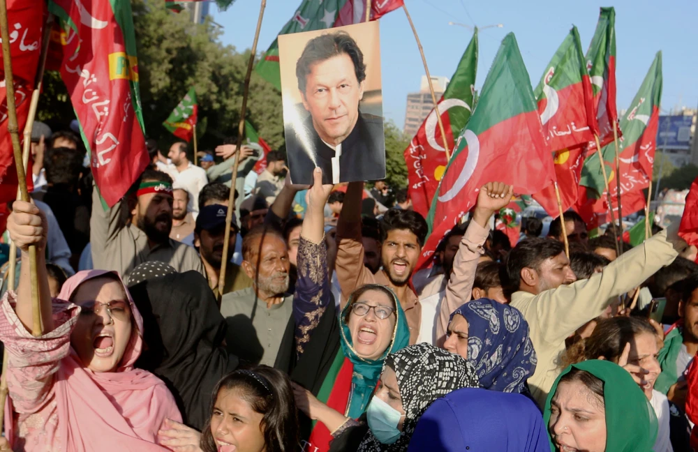 Supporters of former Pakistani Prime Minister Imran Khan’s party stage a protest in Karachi on Friday to condemn a shooting incident on their leader’s convoy. (AP)