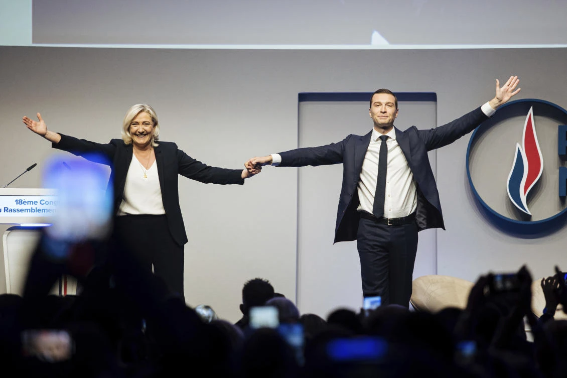 French far right leader Marine Le Pen celebrates with newly elected leader of the National Rally president Jordan Bardella during the party congress in Paris, Saturday, Nov. 5, 2022. (AP)