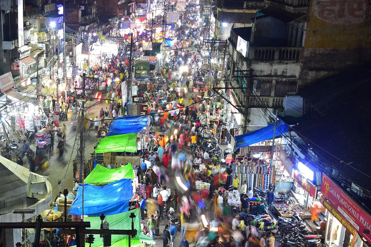 This picture taken on Oct. 22, 2022 shows people walking through a market in Allahabad, India. (AFP)