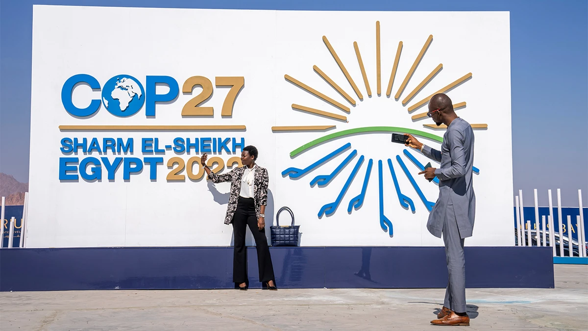 Chadians pose for a photograph at the entrance of the COP27 U.N. Climate Summit, Sunday, Nov. 6, 2022, in Sharm el-Sheikh, Egypt. (AFP)