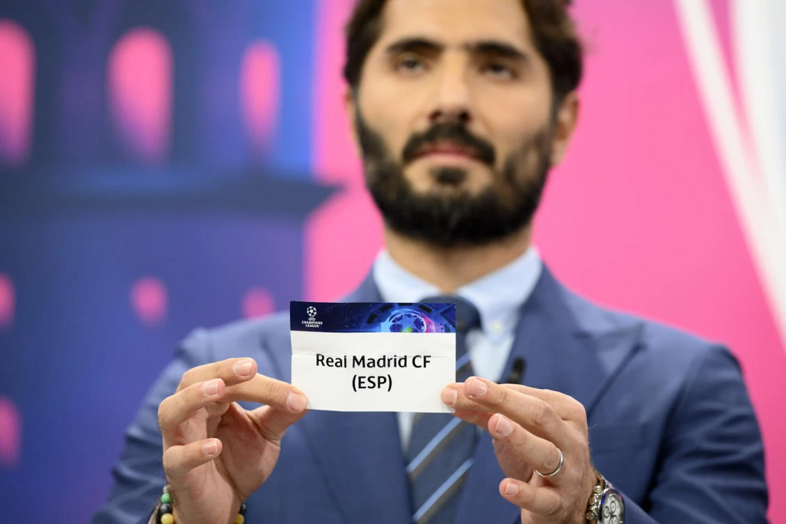 Former Turkish player Hamit Altintop displays the Real Madrid ticket during the UEFA Champions League 2022/23 round of 16 draw, at UEFA HQ in Nyon, Switzerland, Monday, Nov. 7, 2022. (AP Photo)