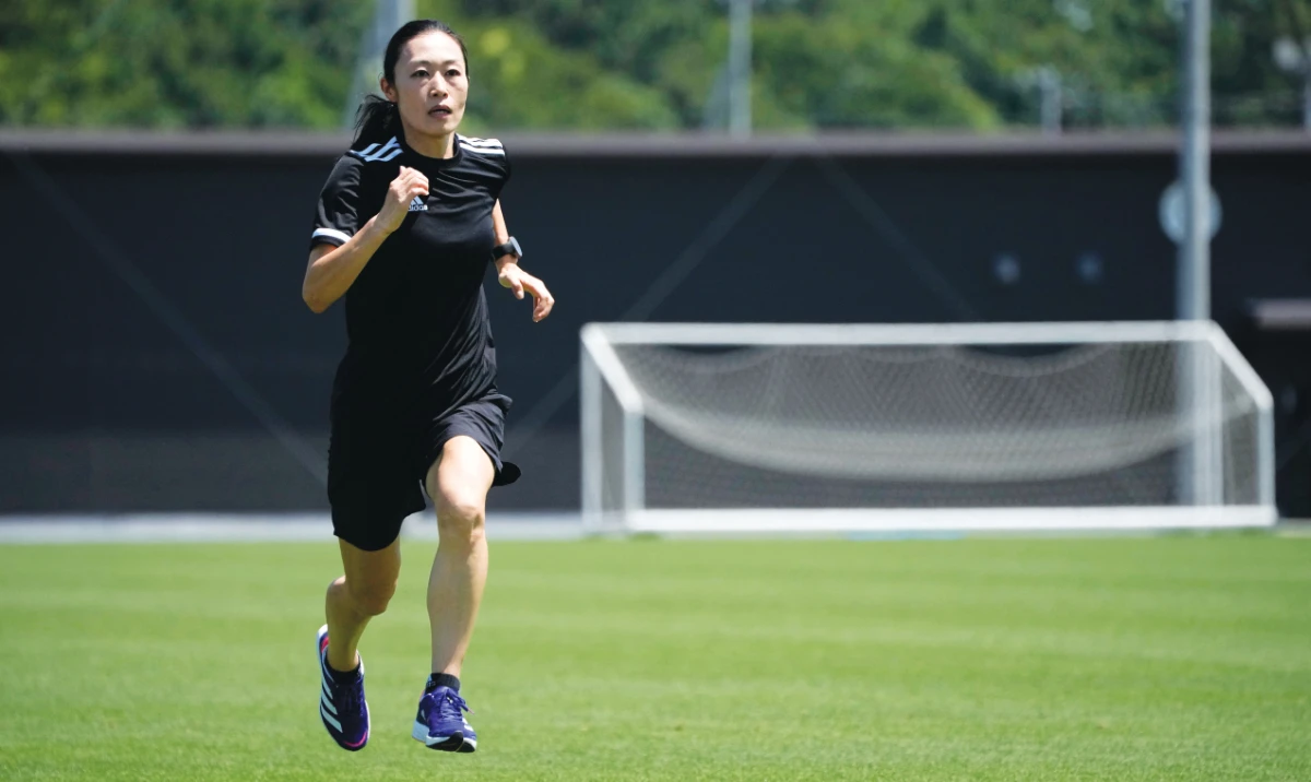 Yoshimi Yamashita of Japan, one of three women picked to be head referees at the men’s soccer World Cup, warms up during a training session on June 27, 2022, at JFA YUME Field in Chiba, near Tokyo. (AP/File)