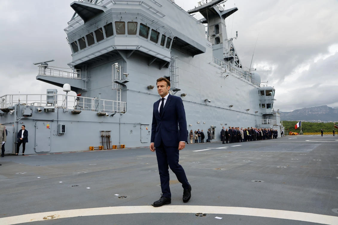 French President Emmanuel Macron walks on the deck of the amphibious helicopter carrier Dixmude docked in the French Navy base of Toulon, France, November 9, 2022. (Reuters)