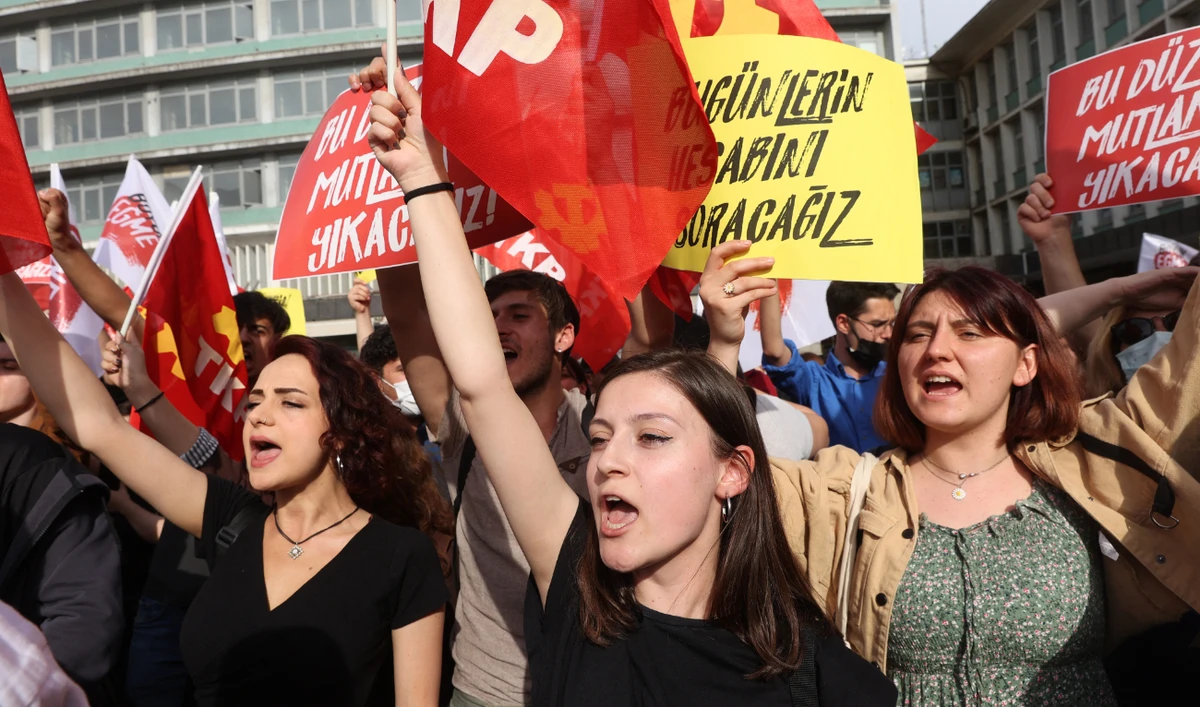 Protesters hold placards and wave flags in Ulus Square in Ankara on April 26, 2022 during a rally in support of civil society leader Osman Kavala. (AFP/File)
