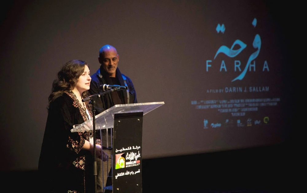Producer Deema Azar and actor Ashraf Barhom introduce "Farha", the closing film during the ninth edition of the Palestine Cinema Days festival, in Ramallah, in the Israeli-occupied West Bank, November 7, 2022. (REUTERS)