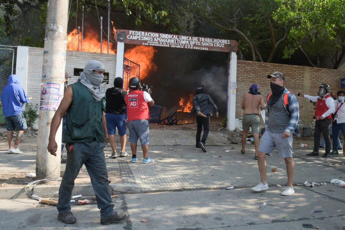 Demonstrators stand outside the vandalized building of the farmer's union during a general strike in Santa Cruz, Bolivia, on November 11, 2022. (REUTERS)