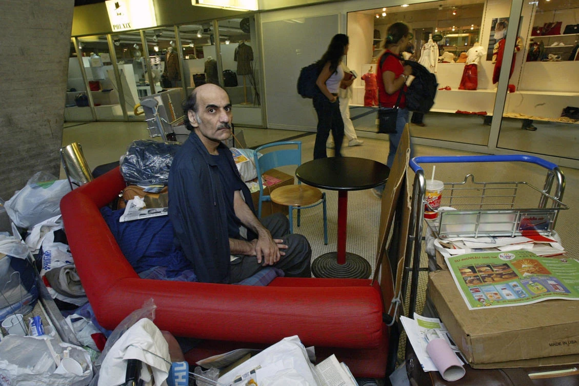 Merhan Karimi Nasseri sits among his belongings at Terminal 1 of Roissy Charles De Gaulle Airport, north of Paris on Aug. 11, 2004. (AP/File)