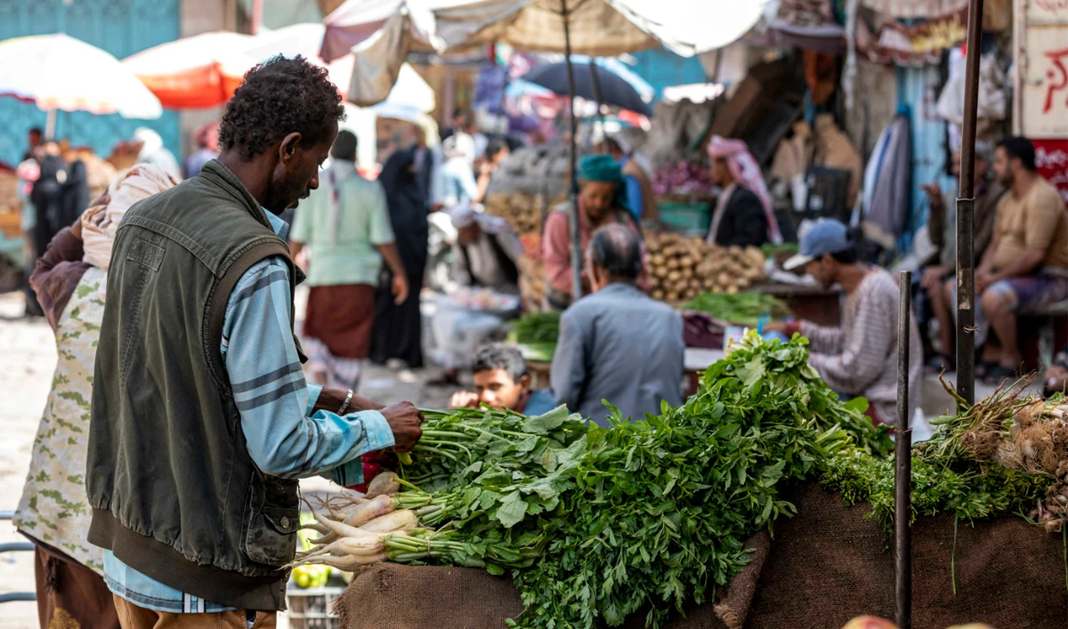 People shop for fresh produce in an open-air market in Taiz. Residents have welcomed police action to restore calm in the city. (AFP/File)