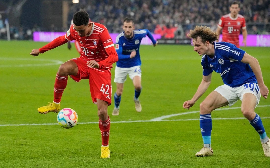 Bayern's Jamal Musiala passes the ball during the German Bundesliga soccer match between FC Schalke 04 and Bayern Munich in Gelsenkirchen, Germany. (AP)