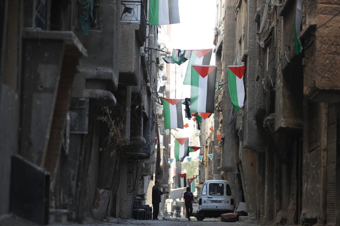 Some return to war-battered hub of Palestinian life in Syria