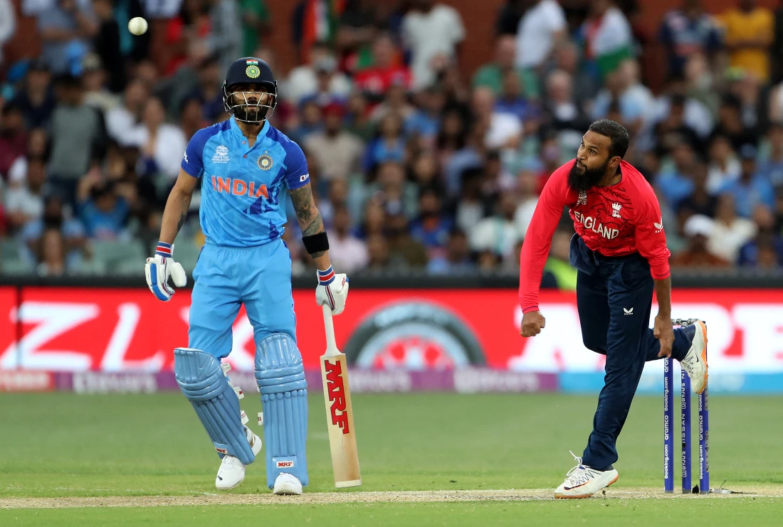 England's Adil Rashid bowls past India's Virat Kohli (L) during the ICC men's Twenty20 World Cup 2022 semi-final cricket match between England and India. (File/AFP)