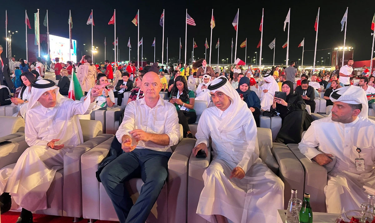 FIFA President Gianni Infantino with Qatar Airways CEO Akbar Al Bake and fans at the Passenger Overflow Area of Hamad International Airport in Doha on Thursday. (Reuters)