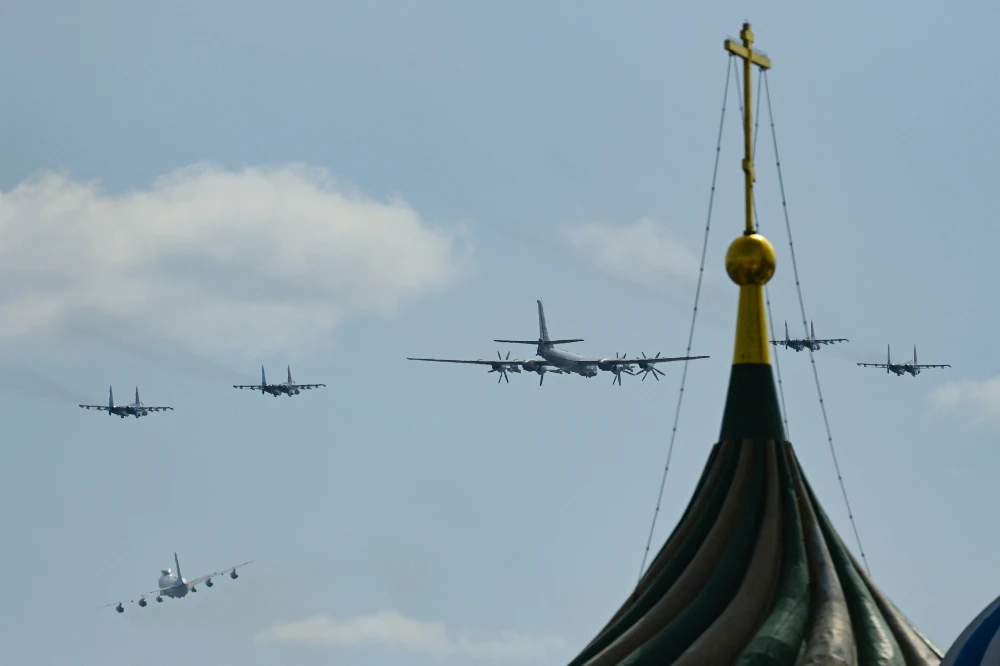 A Russian Tupolev TU-95 and Sukhoi Su-35s fighter jets fly over Red Square during the general rehearsal of the Victory Day military parade in central Moscow on May 7, 2022. (AFP)