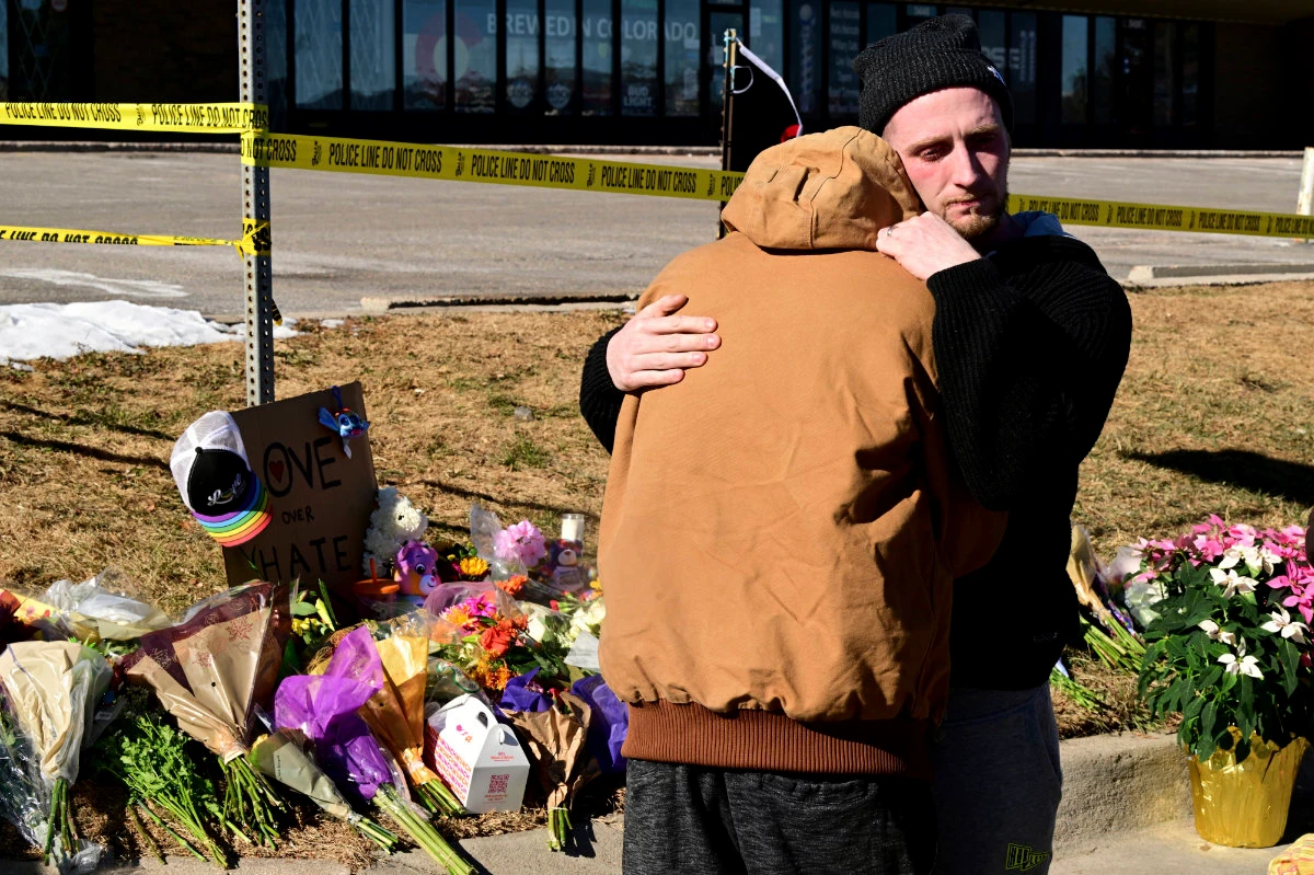 Tyler Johnston, right, comforts Joshua Thurman, a survivor of the Colorado Springs nightclub attack on Nov. 20, 2022. (The Denver Post via AP)