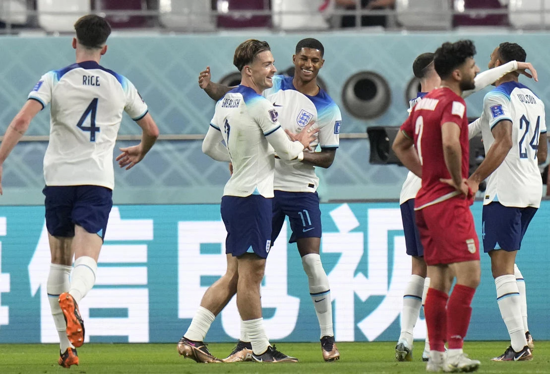 England’s Jack Grealish, center, celebrates with England’s Marcus Rashford after scoring his side’s sixth goal during the World Cup match between England and Iran at the Khalifa International Stadium in Doha. (AP)