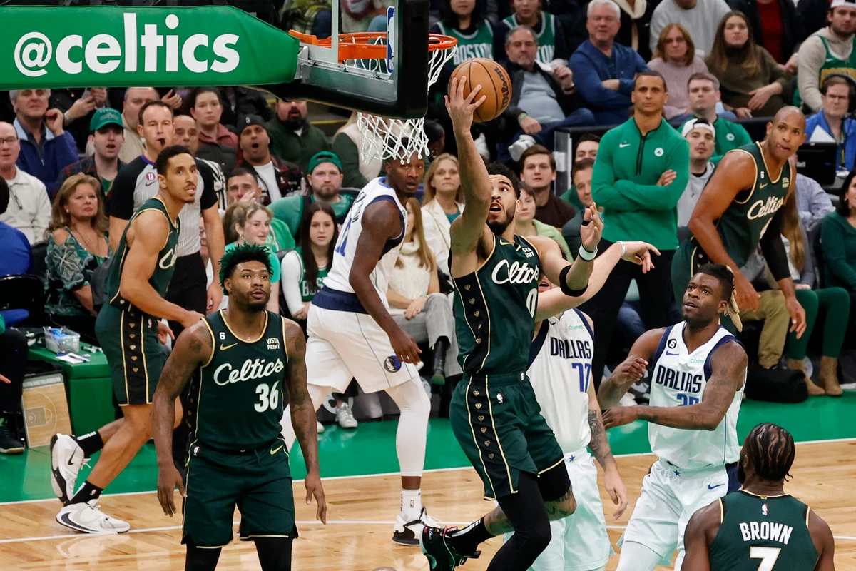 Boston Celtics forward Jayson Tatum drives to the basket past Dallas Mavericks defenders during the first half of an NBA basketball game Wednesday in Boston. (AP)