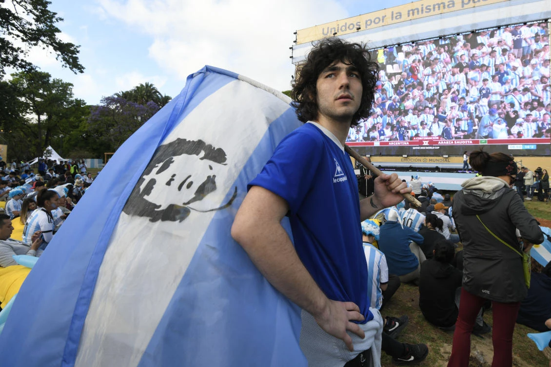 Above, a fan holds a Maradona fla in the Palermo neighborhood of Buenos Aires in Argentina. (AP)