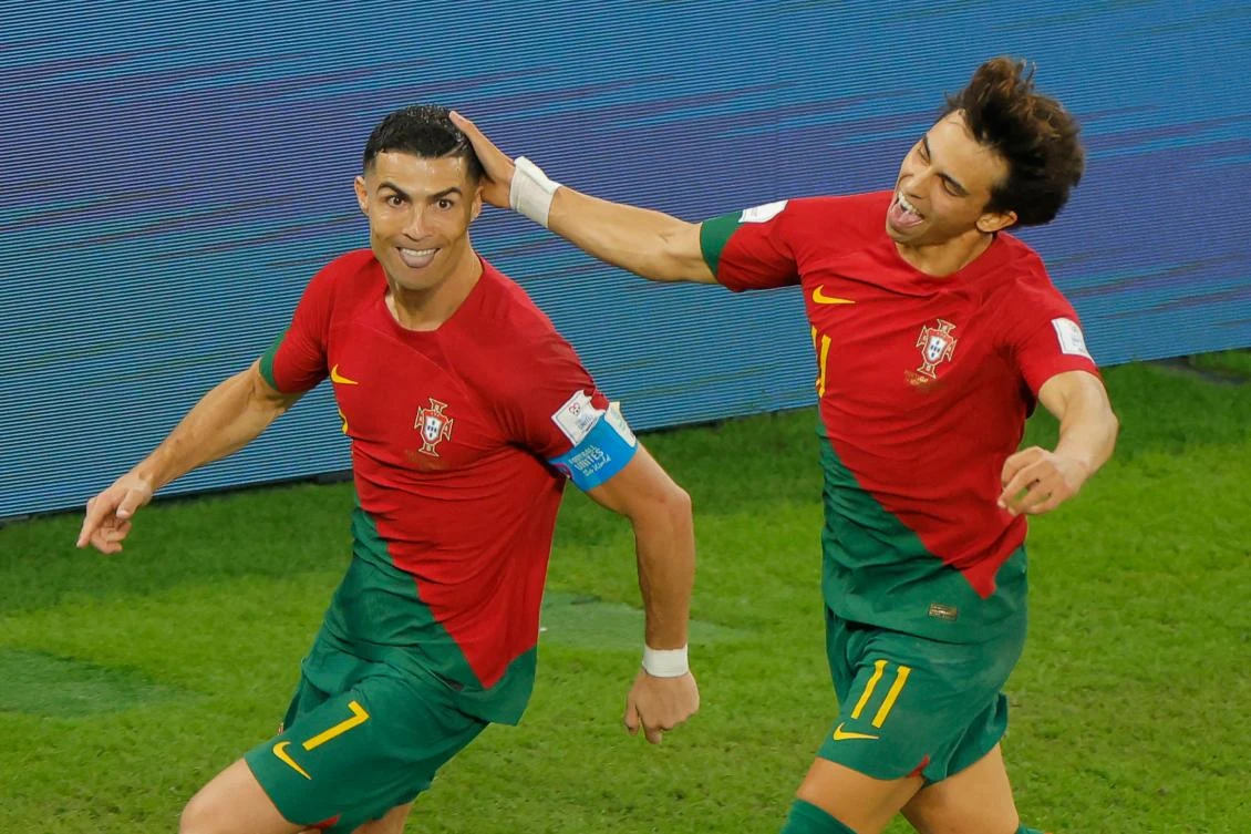 Portugal’s Cristiano Ronaldo celebrates with Joao Felix after scoring his team’s first goal from the penalty spot during their Qatar 2022 World Cup match at Stadium 974 in Doha on Thursday. (AFP)