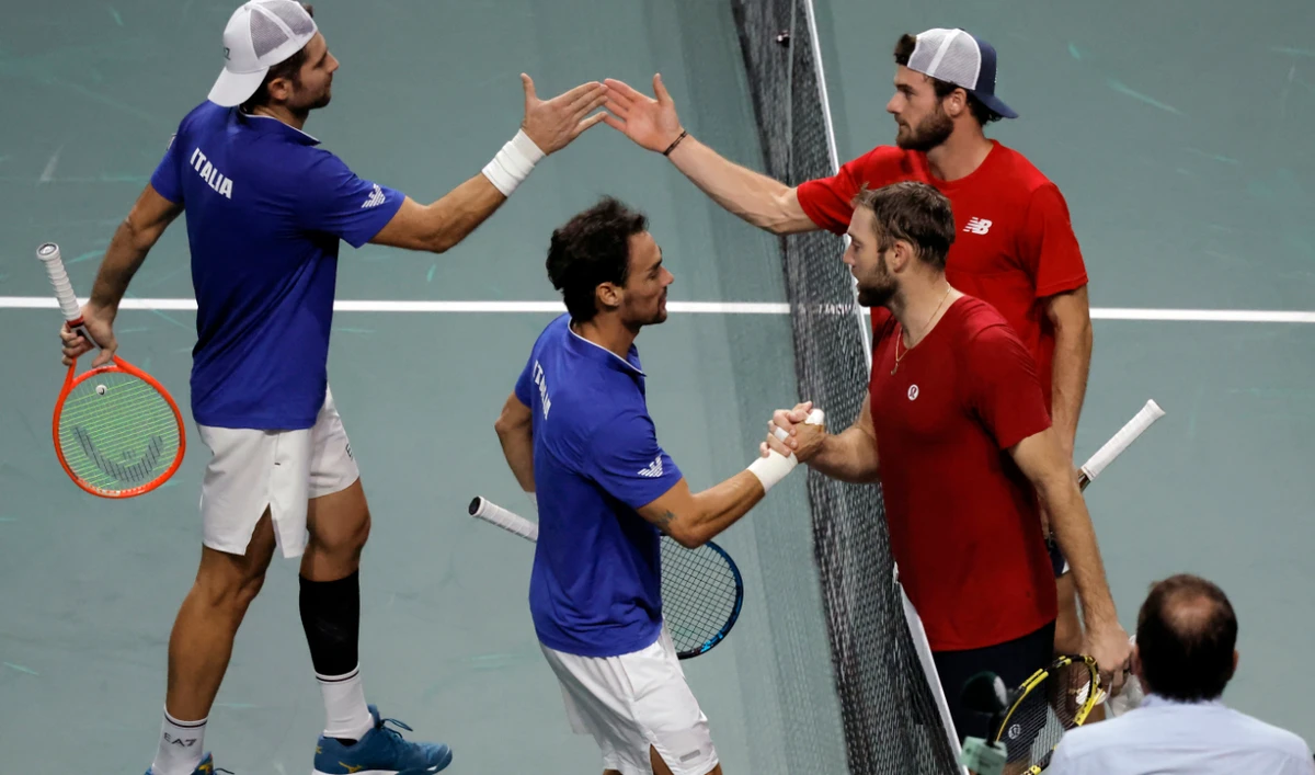 Italy's Simone Bolelli and Fabio Fognini shake hands with Tommy Paul and Jack Sock of the US after winning their doubles match in the Davis Cup quarterfinal on Thursday. (Reuters)