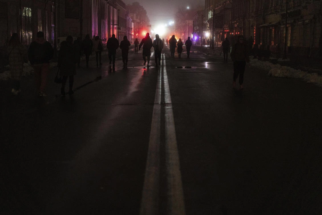People walk at the city center which lost electrical power after yesterday’s Russian rocket attack in Kyiv, on Thursday. (AP)
