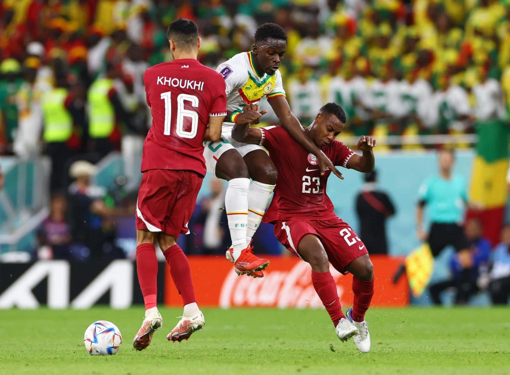 Qatar’s Assim Madibo and Boualem Khoukhi in action with Senegal’s Bamba Dieng during their FIFA World Cup Qatar 2022 Group A match at Al Thumama Stadium, in Doha on Friday. (Reuters)