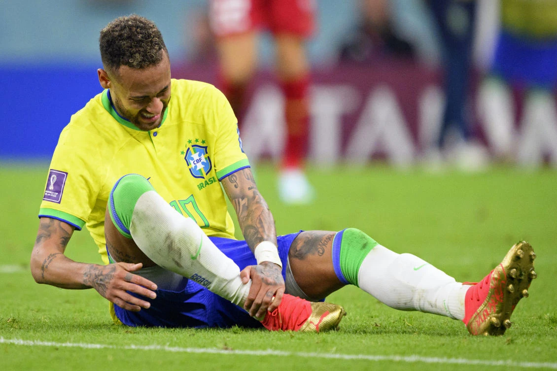 Brazil’s Neymar grabs his ankle after an injury during the World Cup group G match against Serbia, at the the Lusail Stadium in Lusail, on Thursday. (AP)
