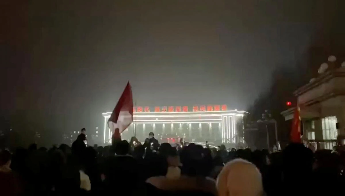 Crowds chanted ‘End the lockdown!,’ pumping their fists in the air as they walked down a street, according to videos circulated on Chinese social media. (Reuters)