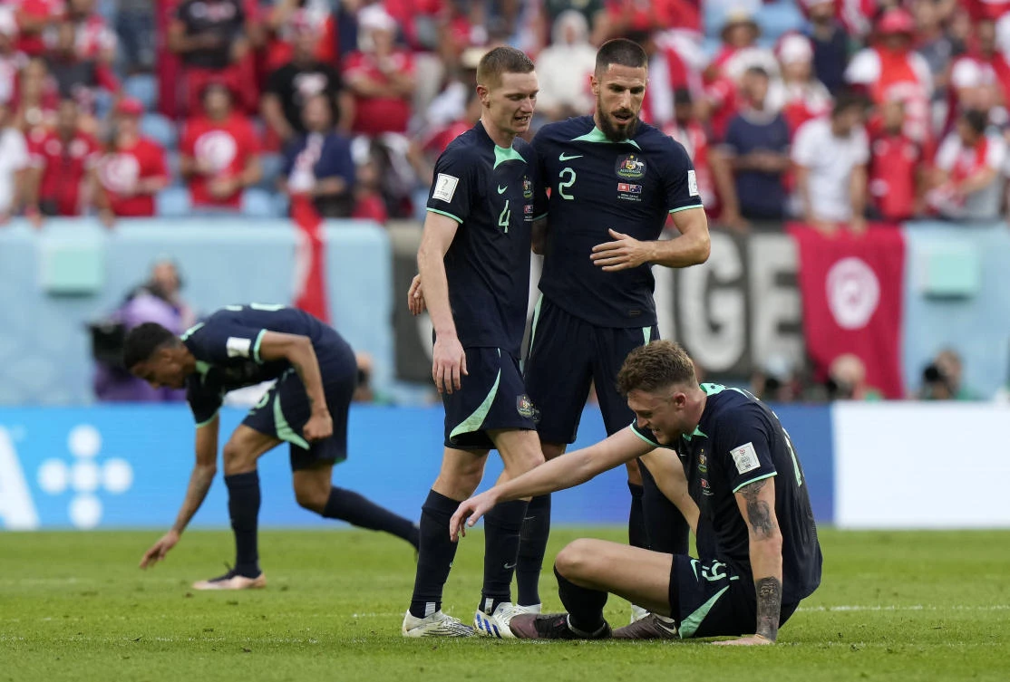 Australia’s players stand on the pitch after their World Cup group D match against Tunisia at the Al Janoub Stadium in Al Wakrah on Saturday. (AP)