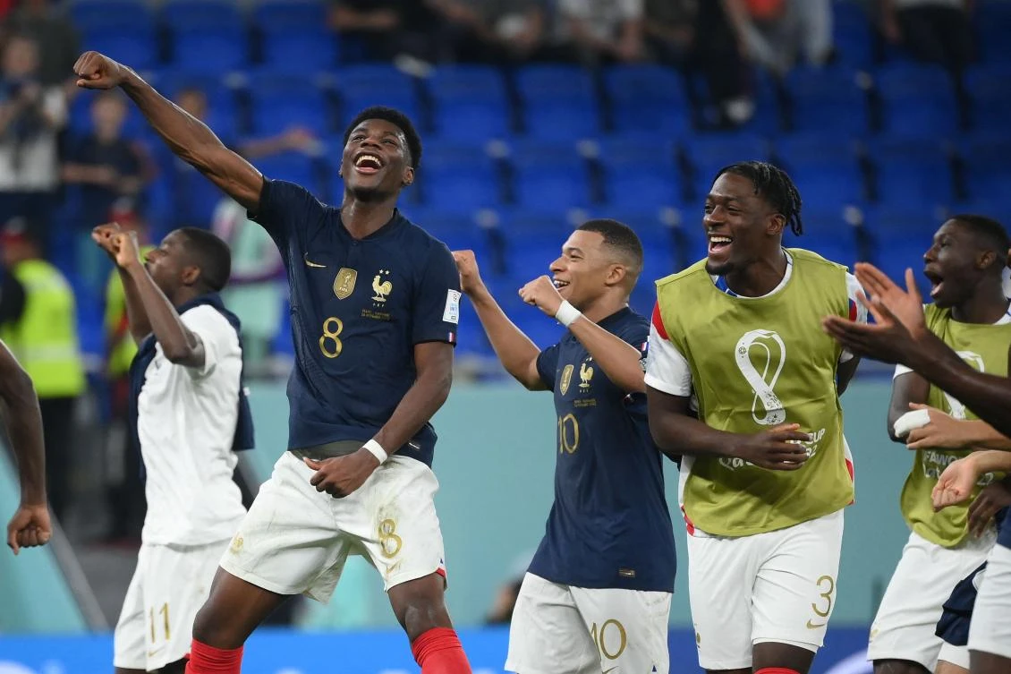 France’s midfielder Aurelien Tchouameni, forward Kylian Mbappe and defender Axel Disasi celebrate at the end of their Qatar 2022 World Cup Group D match against Denmark at Stadium 974 in Doha on Saturday. (AFP)